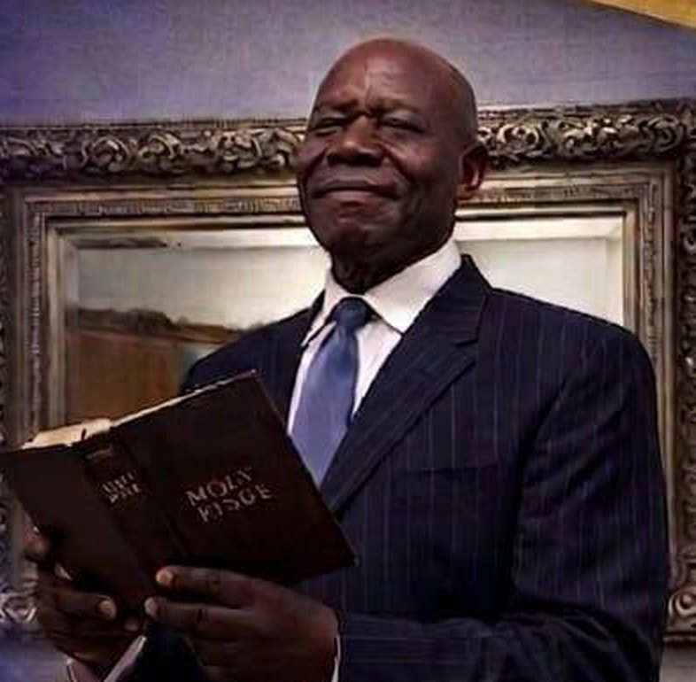 Bishop Maxwell Roberts holding an open Bible